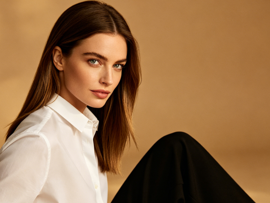 Portrait of a mature European woman with straight hair, elegant minimalist outfit, warm studio lighting, vintage light brown background, neat straight hairstyle, original image for AI retro French curly hair effect