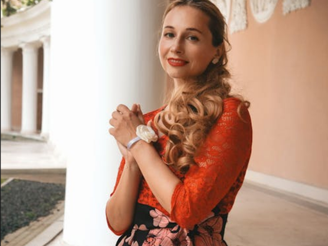 Original elegant European woman half-body portrait, European architecture colonnade background, golden curly hair with red lace top and floral skirt, sophisticated styling poised posture, natural light portrait photography, 4:3 ratio AI color stencil style comparison reference