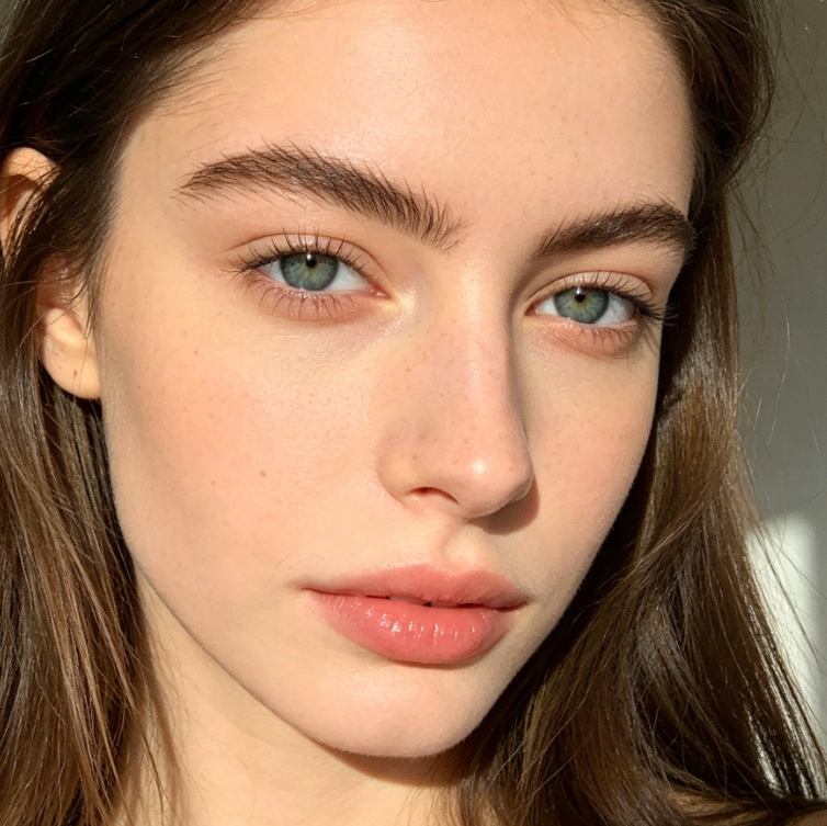 Frontal portrait of European woman, eyebrows trimmed into neat balanced straight brows with symmetrical shape, matching casual daily makeup style