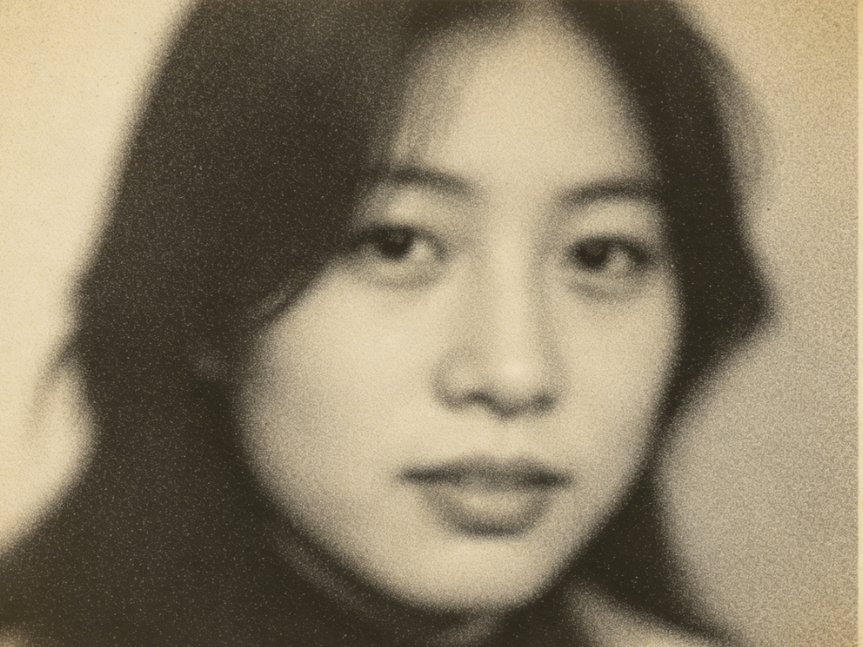 10-year-old vintage photo portrait, yellowed and blurry with scan noise, unclear facial features, faded and desaturated colors