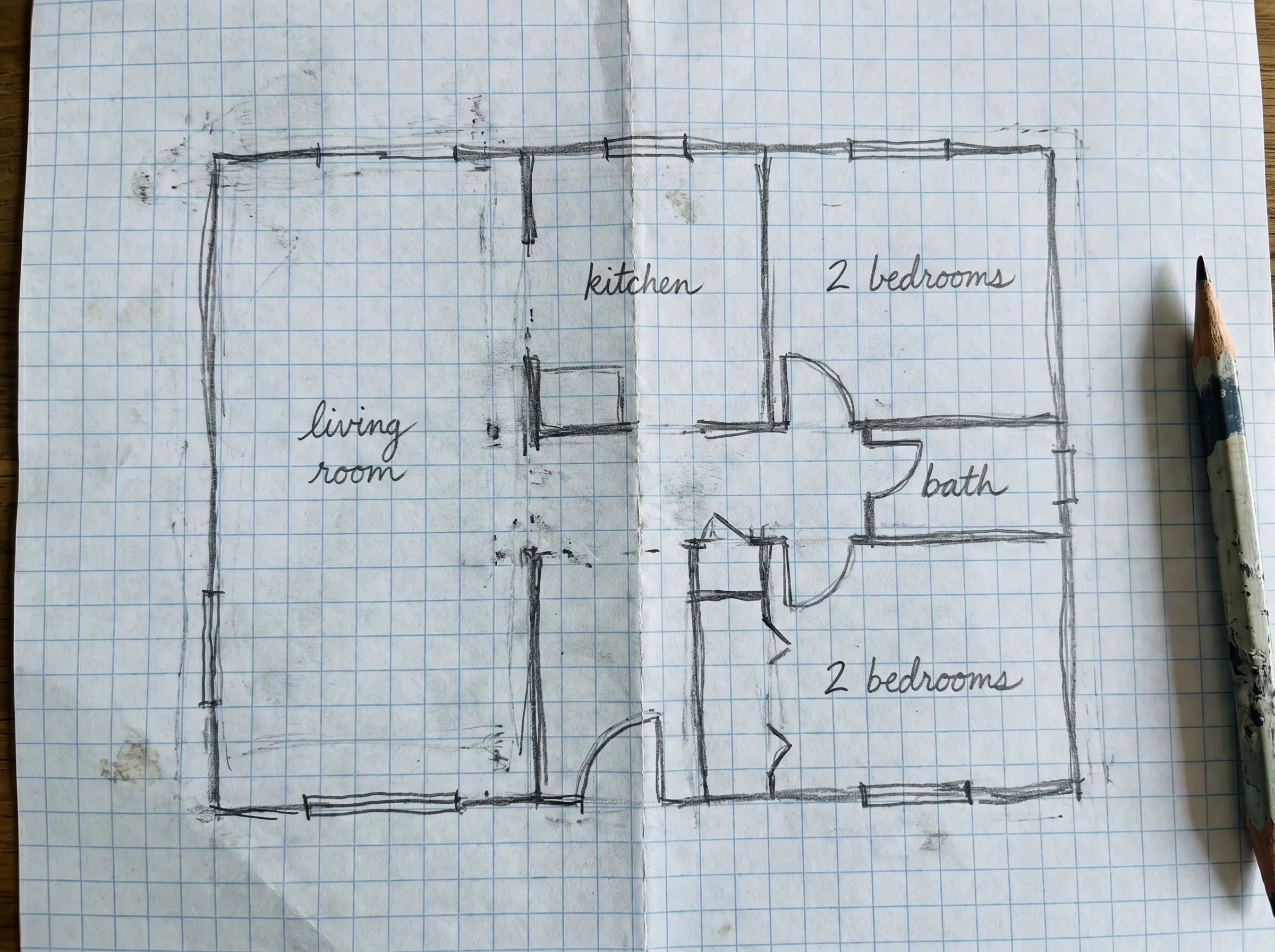 Hand-drawn pencil sketch of a floor plan on paper