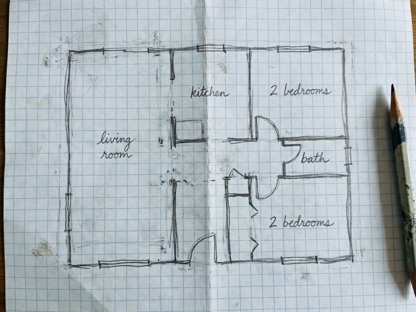 Hand-drawn pencil sketch of a floor plan on paper