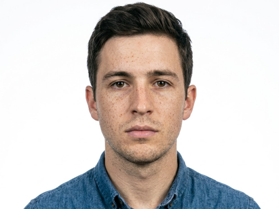 Frontal portrait of the same man with the cluttered background removed. His expression is calm and neutral, looking straight at the camera against a pure white background, presenting a standard passport or visa photo style.