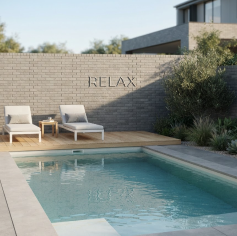 A 1:1 high-end architectural render of a minimalist backyard pool, similar to the reference image. A clean rectangular pool with ripples on the surface is surrounded by smooth gray concrete and light oak decking. Two white loungers face the water. On the textured gray brick wall